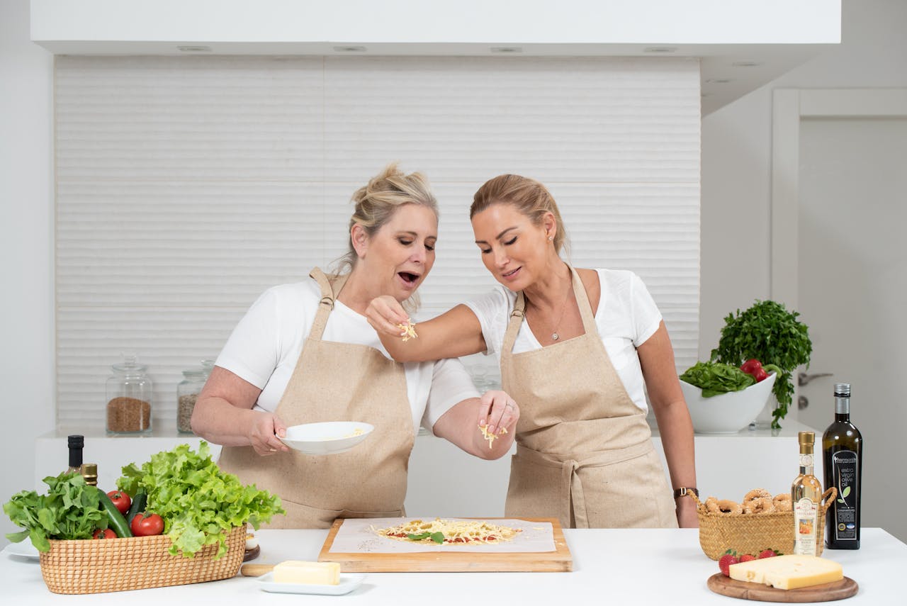 Two women preparing a delicious meal with fresh ingredients in a modern kitchen.